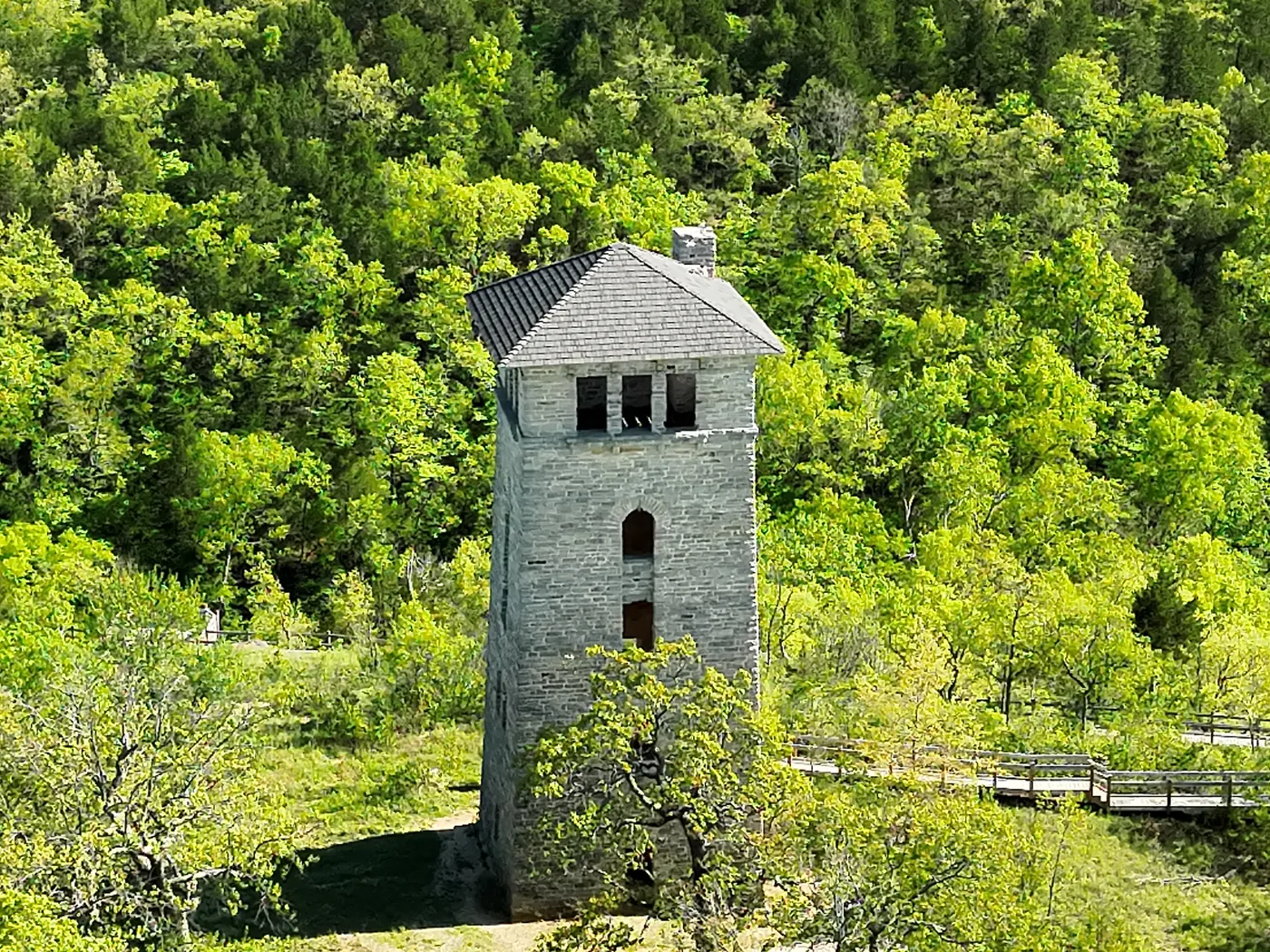 Aerial view of a stone tower surrounded by dense green trees at Ha Ha Tonka State Park.