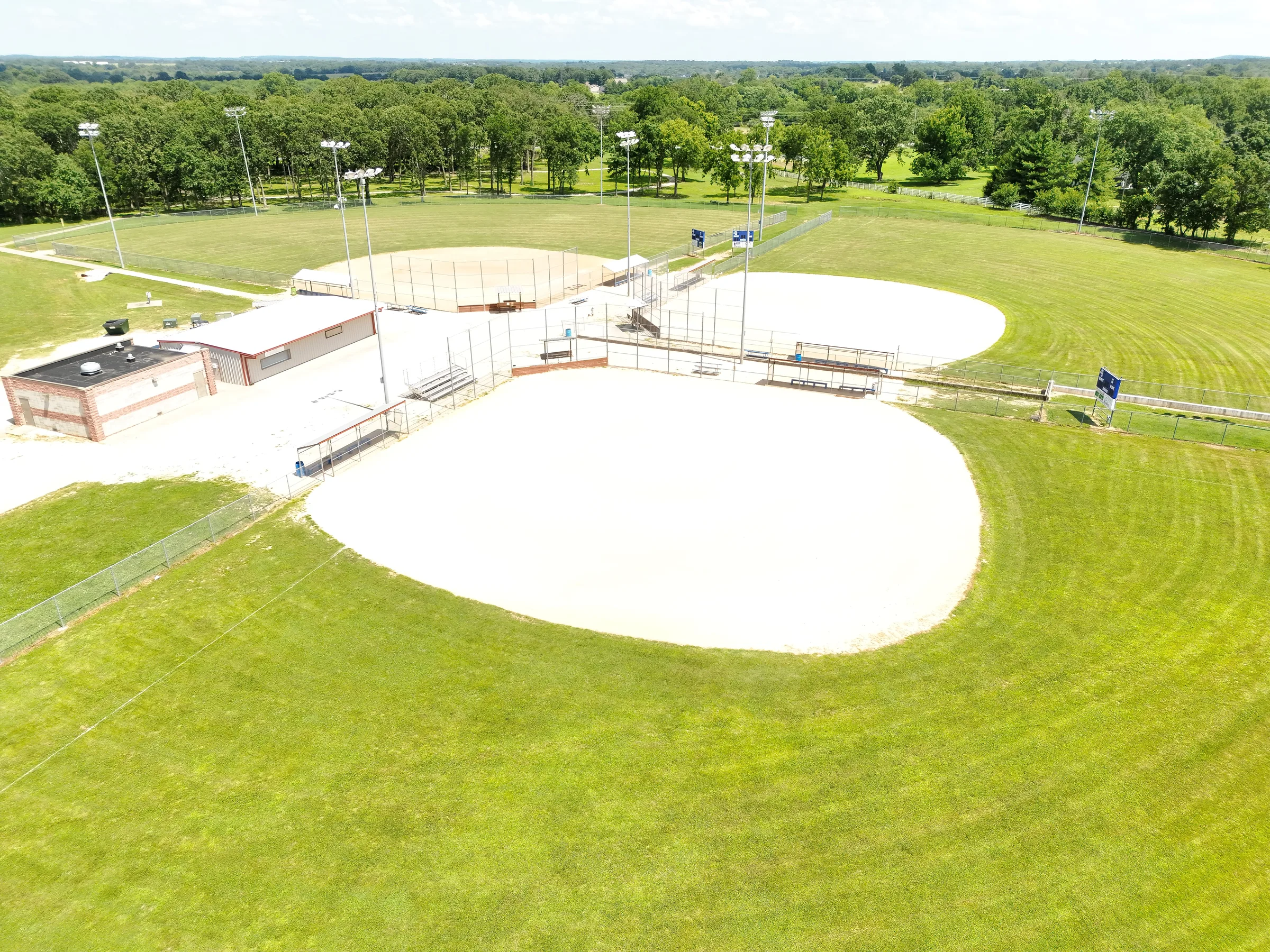 Oblique aerial view of the central Fullerton Ball Fields diamonds, support buildings, and surrounding outfields in Bolivar, Missouri.