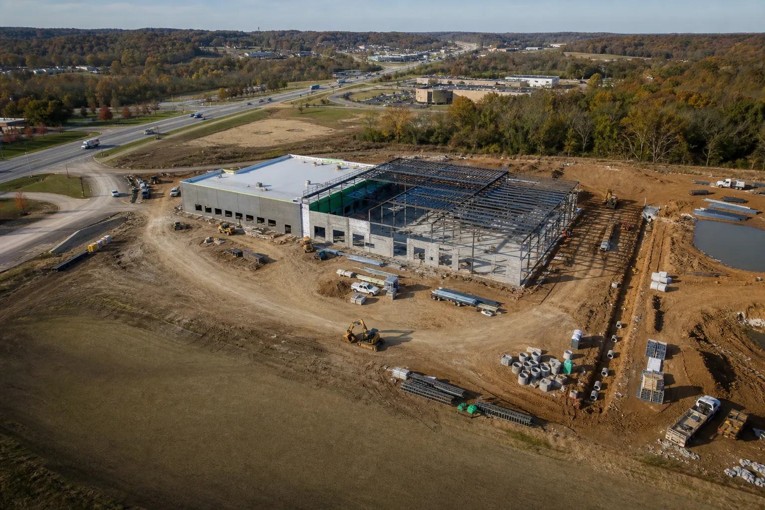 Aerial construction progress sequence showing a commercial site at multiple milestones.
