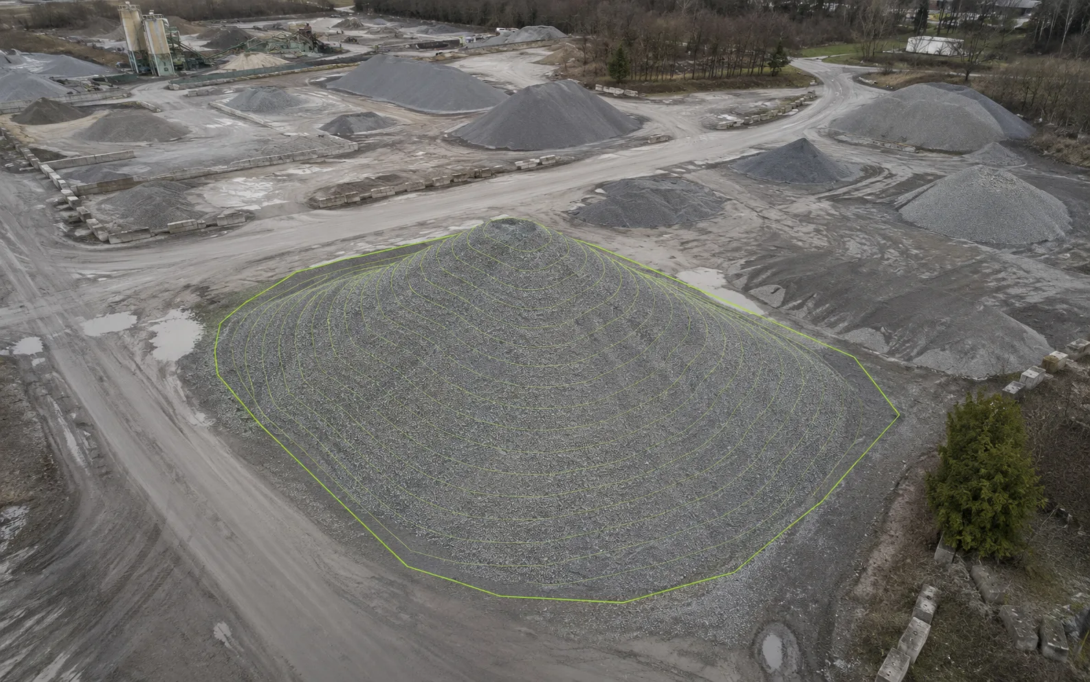 Aerial stockpile view with contour-style reference lines for approximate volume documentation support.